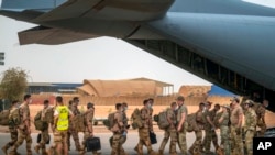 FILE - French Barkhane force soldiers who wrapped up a four-month tour of duty in the Sahel leave their base in Gao, Mali, June 9, 2021