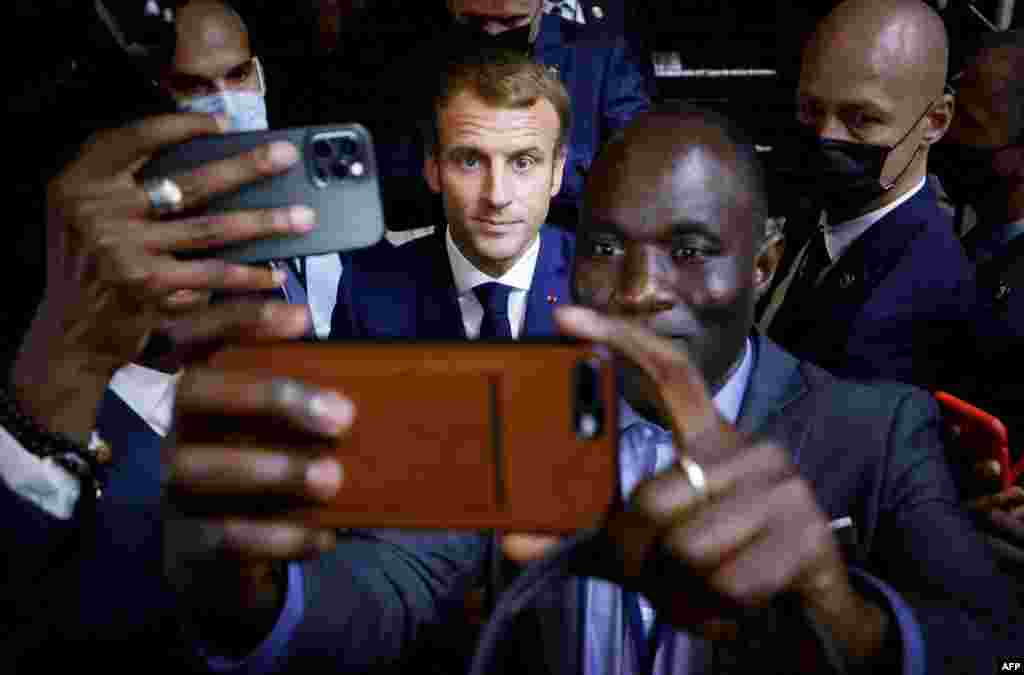 French President Emmanuel Macron, center, poses for a selfie after a basketball game during an Africa-France 2021 Summit in Montpellier, southern France.