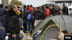 Many of the masses of migrants from the Middle East and Africa, like these in Opatovac, Croatia, escaped extremist groups and are traveling in search of what they call "normal lives." (VOA / H. Murdock)