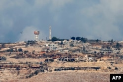 A picture taken from northern Israel along the border with Lebanon shows damaged and destroyed buildings in the southern Lebanese village of Maroun al-Ras on Nov. 12, 2024.