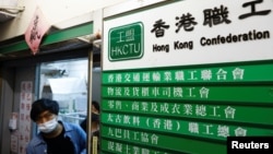 A man walks out of a Hong Kong Confederation of Trade Unions (HKCTU) office, in Hong Kong, China, Sept. 19, 2021.