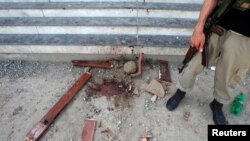 A policeman stands guard over evidence at the entry to the dorm where Mashal Khan, accused of blasphemy, was killed by a mob at Abdul Wali Khan University, in Mardan, Pakistan, April 14, 2017. 