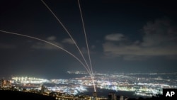 Israel's Iron Dome air defense system fires to intercept rockets that were launched from Lebanon, as seen from Haifa, northern Israel, Sept. 23, 2024. 