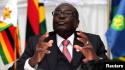 Zimbabwe President Robert Mugabe speaks at the 34th Southern African Development Conference (SADC) summit in Victoria Falls, August 18, 2014. 