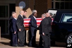 Former and current U.S. Secret Service agents assigned to the Carter detail move the flag-draped casket of former President Jimmy Carter at Phoebe Sumter Medical Center in Americus, Georgia, Jan. 4, 2025.