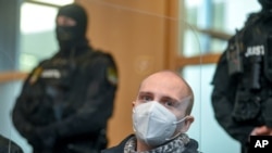 Defendant Stephan Balliet sits in a courtroom before the verdict at his trial, in Magdeburg, Germany, Dec. 21, 2020. 