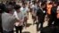 FILE - Chinese citizens who have been arrested over an alleged internet scam line up before a deporting back to China, at the international airport in Phnom Penh, Cambodia.