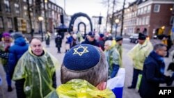 FILE - A protestor wearing a kippa attends a demonstration simultaneously at the hearing at the ICJ on a genocide complaint by South Africa against Israel, in The Hague, January 11, 2024.