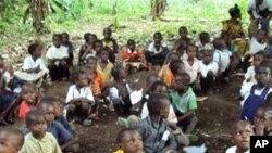 Refugee children from the Democratic Republic of Congo attend class in a forest near Gangania, more than 850 km north of Brazzaville, the capital of neighboring Congo. Most of the teachers are also refugees who fled inter-ethnic violence in the northweste