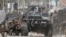 FILE - Government soldiers take cover during a firefight with Muslim rebels from the Moro National Liberation Front (MNLF) in Zamboanga city in southern Philippines September 12, 2013.