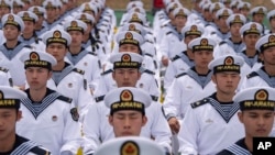 FILE - Chinese sailors sit in rows during a tour arranged for foreign journalists, a day before the opening of the West Pacific Naval Symposium in Qingdao in eastern China's Shandong province, April 21, 2024. 