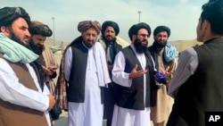 Taliban officials are interviewed by journalists inside the Hamid Karzai International Airport after the US withdrawal in Kabul, Afghanistan, Aug. 31, 2021.