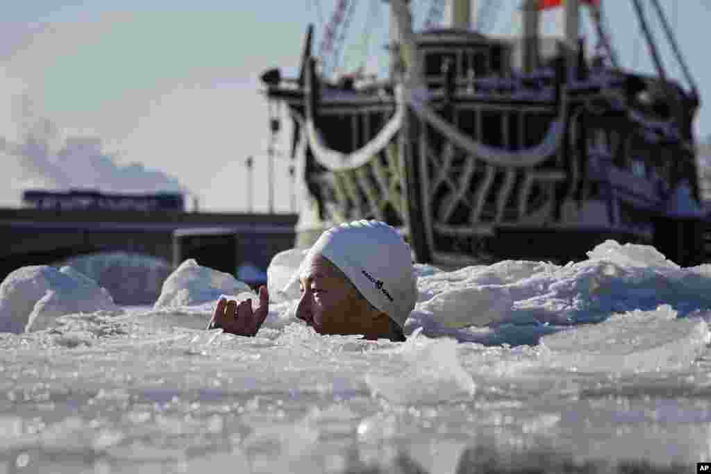 A woman bathes in an ice hole in the Neva River, in St. Petersburg, Russia.