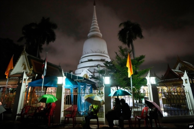 Locals wait in line overnight for free coronavirus testing at Wat Phra Si Mahathat temple in Bangkok, Thailand, Friday, July 9, 2021.