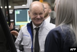 German Chancellor and Social Democratic Party main candidate Olaf Scholz visits Volkswagen's electric fleet production line in Emden, Germany, on Feb. 18, 2025, during an election campaign event.