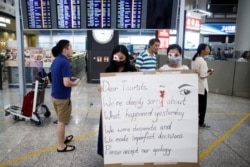 Anti-government demonstrators apologize for yesterday's clashes with police at the airport in Hong Kong, Aug. 14, 2019.