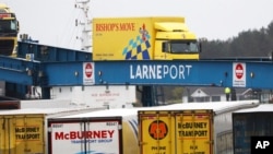 FILE - Vehicles disembark from a ferry at Larne, Northern Ireland, Feb. 2, 2021. Loyalist paramilitary groups in Northern Ireland are temporarily withdrawing support for a 1998 peace accord because of disruption caused by new post-Brexit trade rules.