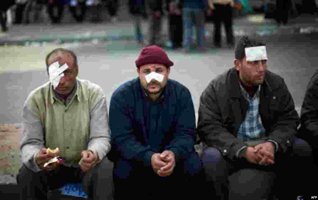 Wounded Egyptian anti government protesters sitin Cairo's main square, Egypt, Egypt, Thursday, Feb. 3, 2011. New clashes are heating up and shots are being fired in the air around Cairo's central Tahrir Square as anti-government protesters push back regi