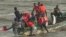 Rescuers help victims of a boating accident near Guinea, September 1, 2012.