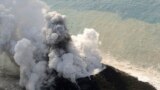 Smoke from an erupting undersea volcano forms a new island off the coast of Nishinoshima, a small uninhabited island, in the southern Ogasawara chain of islands, Japan, in this picture provided by Kyodo. 