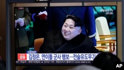 FILE - People watch a TV news program reporting about North Korea's test-fire of a "new-type tactical guided weapon," with a file footage of North Korean leader Kim Jong Un, at the Seoul Railway Station in Seoul, South Korea, April 18, 2019.