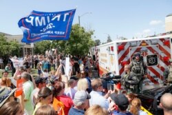 Some supporters of President Donald Trump gather among others protesting a presidential visit outside Miami Valley Hospital, Aug. 7, 2019, in Dayton, Ohio. Victims of a mass shooting in the city's Oregon District on Aug. 4 were there for treatment.