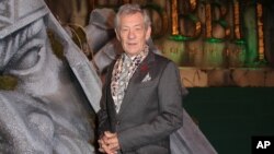 Actor Sir Ian McKellen poses for photographers upon arrival at the world premiere of "The Hobbit: The Battle of the Five Armies" in London, Dec. 1, 2014. 