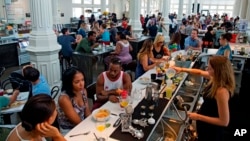 FILE - Crowds gather for Sunday brunch at the renovated St. Roch market in New Orleans, Aug. 16, 2015. After Hurricane Katrina, the city has been helped by billions of dollars in recovery money, buoyed by volunteers and the grit of its own citizens.