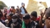 Nigerians in Accra, Ghana, listen to an address at an End SARS demonstration, Oct. 21, 2020. (Stacey Knott/VOA)