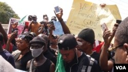 Nigerians in Accra, Ghana, listen to an address at an End SARS demonstration, Oct. 21, 2020. (Stacey Knott/VOA)