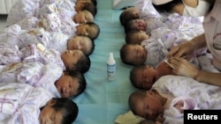 Newly born babies receive vaccines at a hospital in Aksu, Xinjiang Uighur Autonomous Region, August 10, 2012. 