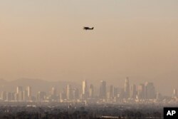 Haze from various wildfires hangs over the downtown skyline, Sept. 11, 2024, in Los Angeles.