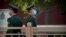 Chinese paramilitary police wearing face masks to prevent the spread of the new coronavirus stand guard along a street near Tiananmen Square in Beijing on April 29, 2020. 