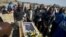 Mineworkers pray over the coffin containing the body of Mpuzeni Ngxande, one of the 34 striking miners that were killed by police on August 16, in front of the rocky outcrop where the men were shot, an informal settlement near the Lonmin mine in Marikana,