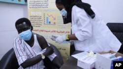 A health care worker administers a dose of the AstraZeneca COVID-19 vaccine, at Jabra Hospital in Khartoum, Sudan, March 11, 2021. 