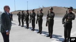 Turkey's President Recep Tayyip Erdogan inspects a military honor guard before addressing supporters in Bursa, Turkey, Aug. 4, 2019. 