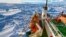 In this image provided by Australasian Antarctic Expedition/Footloose Fotography, Russian ship Akademik Shokalskiy is shown trapped in thick Antarctic ice, 1,500 nautical miles south of Hobart, Australia, Friday, Dec. 27, 2013.