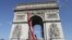 Cranes operate at the Arc de Triomphe in Paris, Aug.24, 2021. The L'Arc de Triomphe, Wrapped project by late artists Christo and Jeanne-Claude will be on view from Sept.18-Oct. 3, 2021.