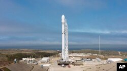 In this Sunday, June 25, 2017, photo released by SpaceX, a SpaceX Falcon 9 rocket is seen before lift off, carrying 10 more satellites for Iridium Communications, from Vandenberg Air Force Base, Calif.
