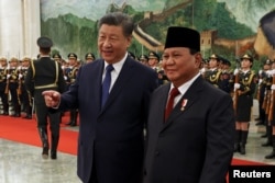 FILE - Chinese President Xi Jinping and Indonesian President Prabowo Subianto attend a welcome ceremony at the Great Hall of the People in Beijing, China, Nov. 9, 2024.