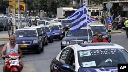 Striking taxi drivers protest part of the country's fiscal recovery program by driving their cars in convoy through the streets of Thessaloniki, Greece, July 20, 2011