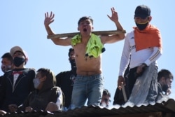 Inmates protest on the roof of a San Sebastian prison, asking for better medical attention amid the pandemic and to be given the results from previously administered COVID-19 tests, in Cochabamba, Bolivia, July 27, 2020.