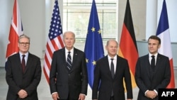 (L-R) British Prime Minister Keir Starmer, US President Joe Biden, German Chancellor Olaf Scholz and French President Emmanuel Macron pose for a family photo at the start of their "Quad meeting" at the Chancellery in Berlin, on October 18, 2024.