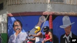 Peinture murale du président nicaraguayen Daniel Ortega, à gauche, et du héros révolutionnaire Cesar Augusto Sandino lors des élections générales à Managua, le 7 novembre 2021.