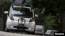 An autonomous self-driving vehicle goes onto the road during a demonstration at one-north business park in Singapore October 12, 2015.