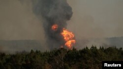 Flames shoot into the sky from a gas line explosion in western Shelby County, Alabama, U.S., October 31, 2016. 