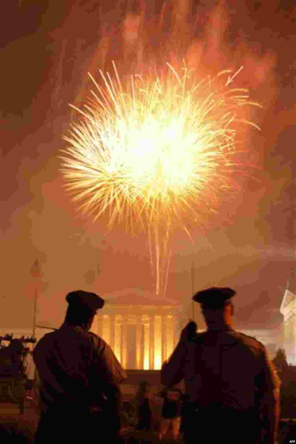 Police officers view fireworks explode over the Philadelphia Museum of Art during an Independence Day celebration Monday, July 4, 2011, in Philadelphia. (AP Photo/Matt Rourke)