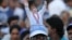 A supporter sports a cut-out of Sri Lankan President Mahinda Rajapaksa on his head, during Rajapaksa’s final public rally for the presidential elections in Kesbewa, about 20 kilometers (12 miles) southeast of Colombo, Sri Lanka, Monday, Jan. 5, 2015.