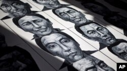 In this photo taken on Dec. 25, 2012, portraits of Tibetans who have self-immolated over the past three years painted by Beijing-based artist Liu Yi are displayed at his studio in Songzhuang art village in Tongzhou, on the outskirts of Beijing.