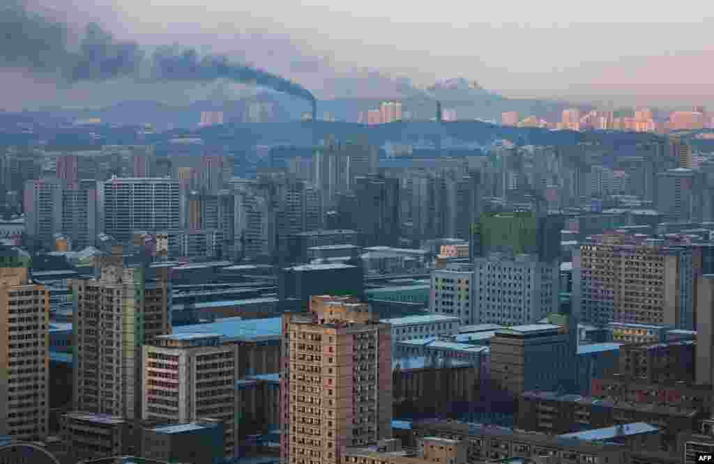 Smoke rises from factories over central Pyongyang, North Korea, Dec. 9, 2011. (AP)